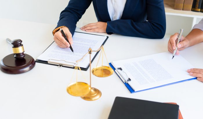 Female Lawyer explaining legal situation and discussing with contract papers, Concepts of law, justice and legal services.